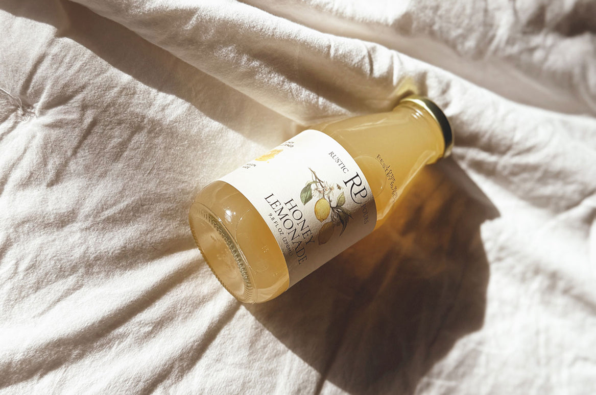 Bottle of lemonade on a white fabric surface